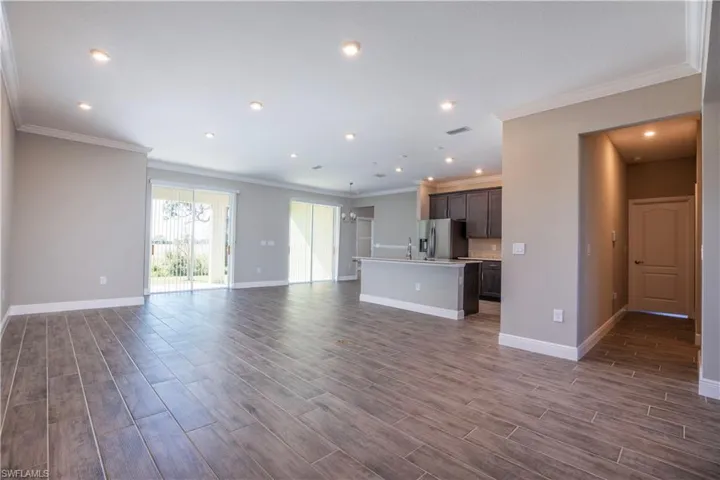 Unfurnished room with dark hardwood / wood-style flooring and ornamental molding