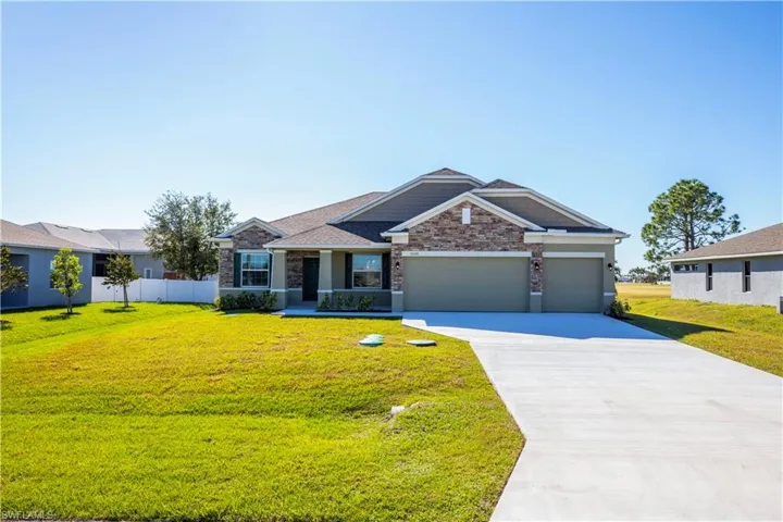 Ranch-style home featuring a front yard