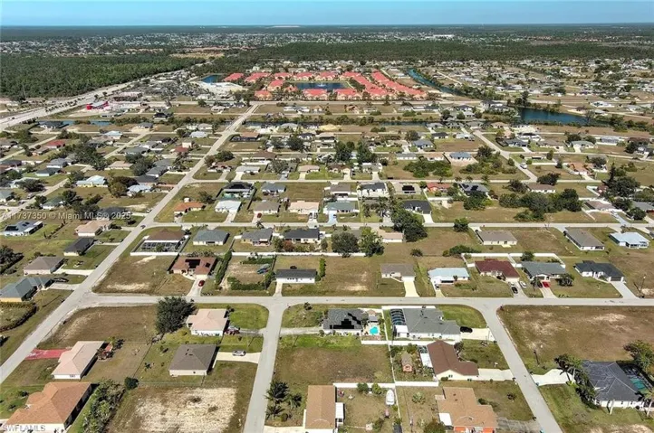 View of property location with nearby suburban area and a nearby body of water