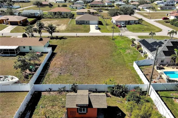 Aerial view of residential area featuring a pool area