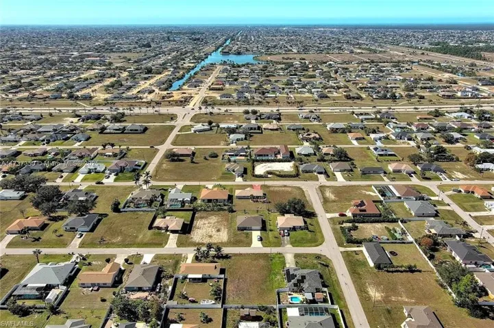 Aerial view of property's location with nearby suburban area