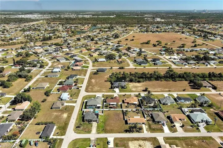 Aerial view of property's location featuring nearby suburban area