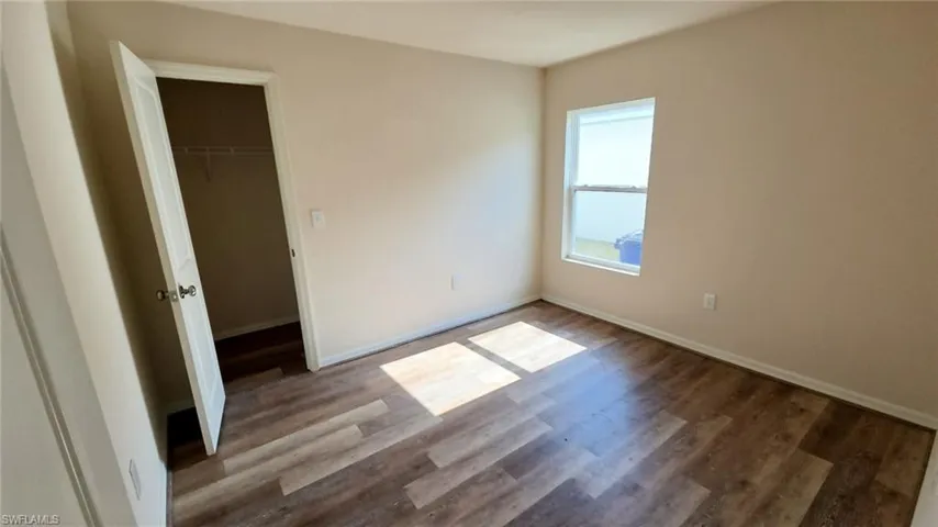 Neutral tone wall paint with wood-finish flooring