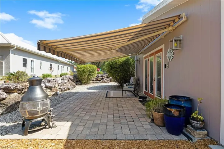 View of patio with remote powered awning