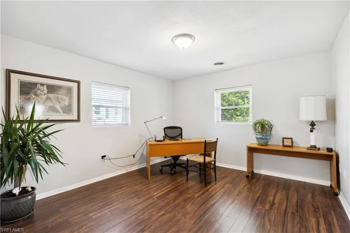 Office featuring dark wood-type flooring