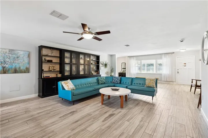 Living room featuring ceiling fan and tile