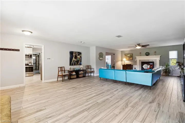 Living room featuring ceiling fan and tile