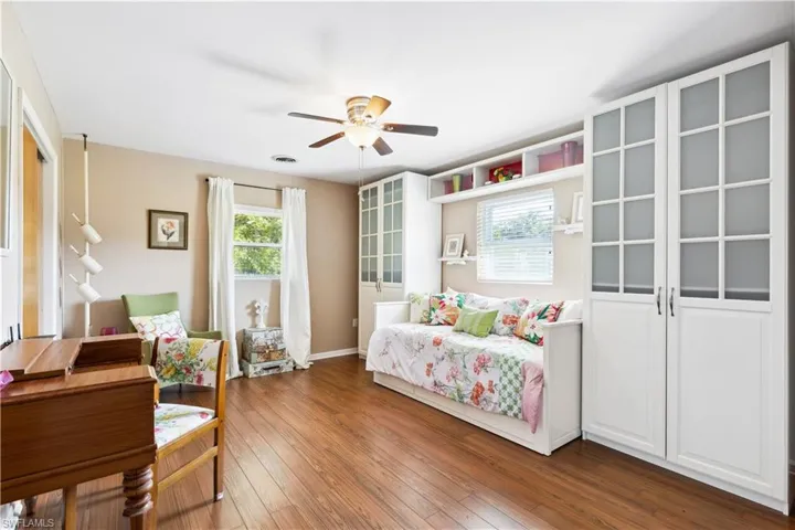 Living area featuring ceiling fan and hardwood / wood-style flooring