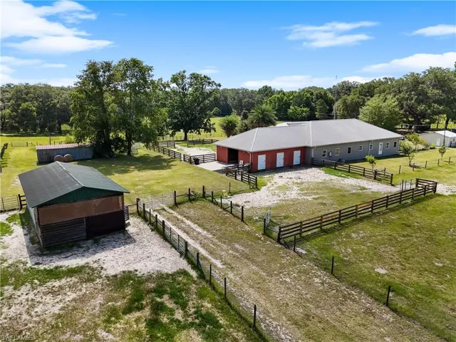 Drone / aerial view of additional home, horse stables, and hay barn
