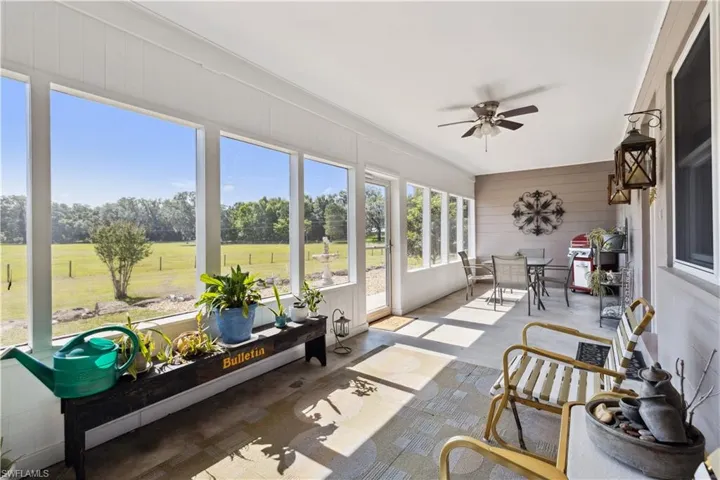 Sunroom featuring ceiling fan