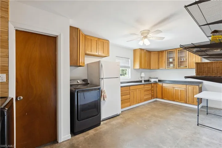 Garage Pantry with ceiling fan, white refrigerator, and washer / clothes dryer