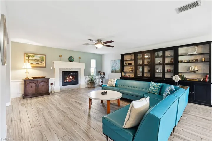 Living room with ceiling fan and tile
