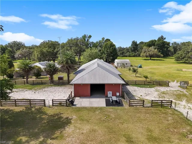 View of horse stables with a yard and a rural view