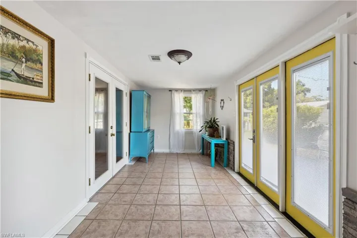 Sunroom featuring french doors
