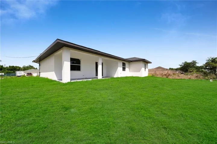 Expansive rear lawn area bordering the property's exterior