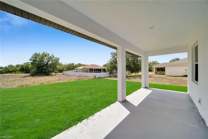 Covered patio featuring a concrete slab and painted support columns