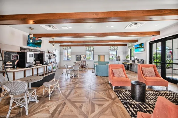 Living room with parquet floors, beamed ceiling, and french doors