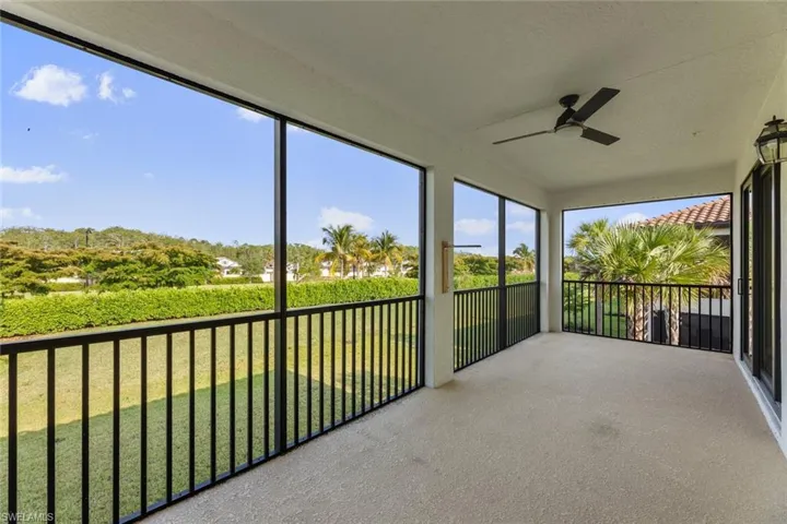 Unfurnished sunroom with ceiling fan