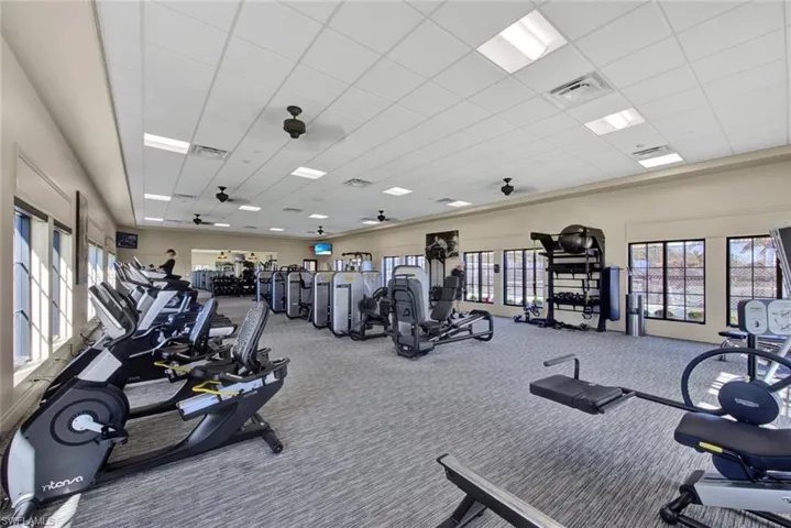 Workout area with carpet floors and a drop ceiling
