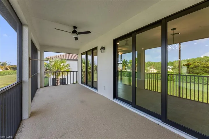 Unfurnished sunroom featuring ceiling fan