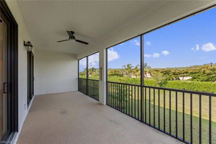 Unfurnished sunroom featuring ceiling fan