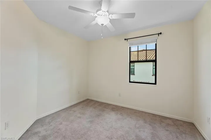 Unfurnished room with ceiling fan and carpet floors