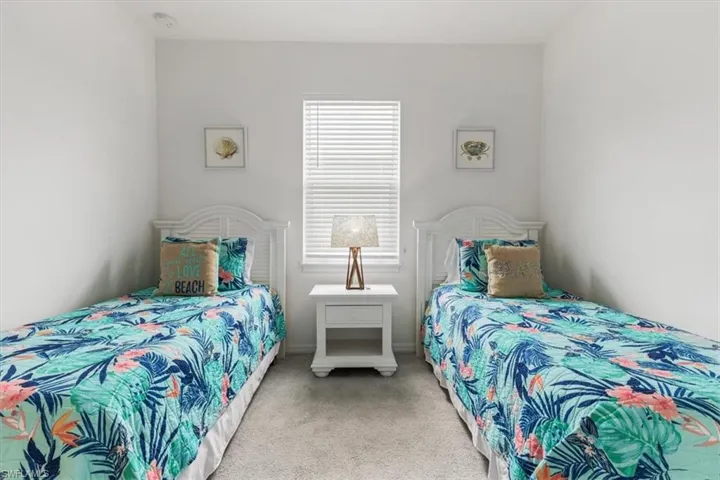 Bedroom with multiple windows and carpet floors