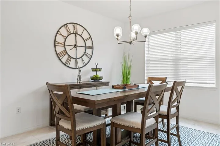 Tiled dining area with an inviting chandelier