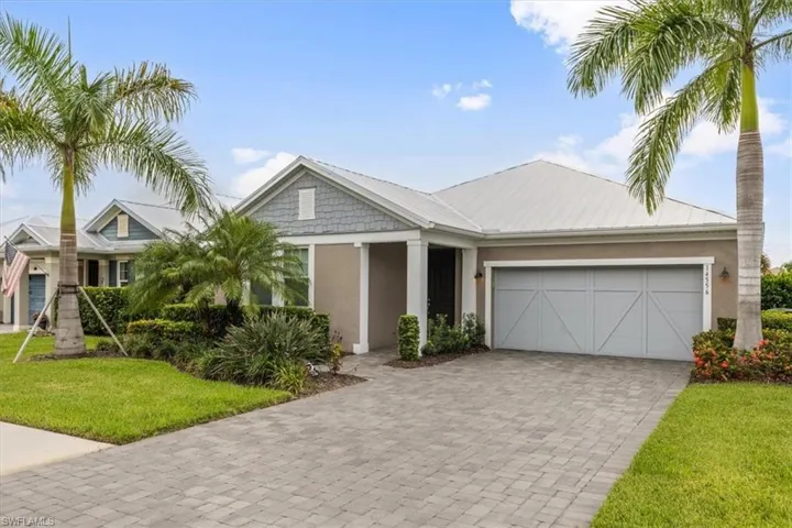 View of front of house with a garage and a front lawn