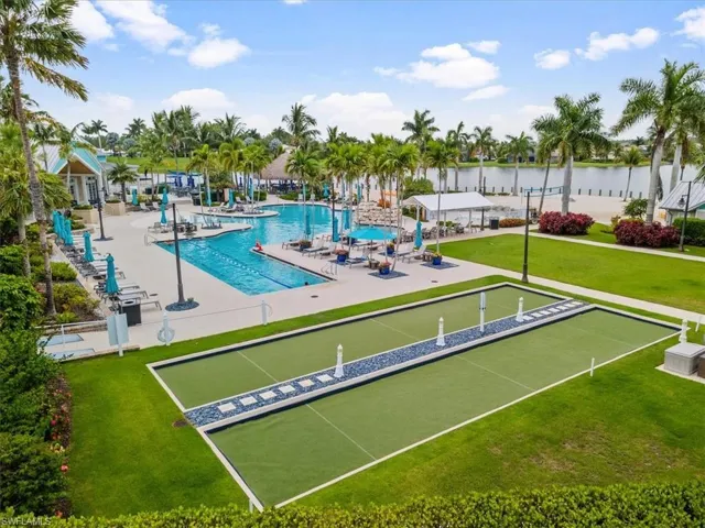 View of swimming pool with a water view and a yard