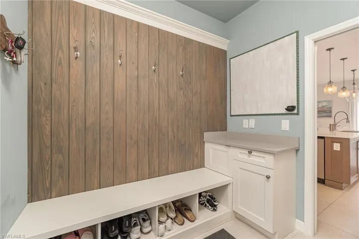 Bench, light tile patterned floors and cabinet