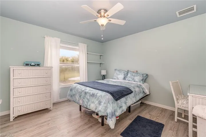 Bedroom with light hardwood / wood-style flooring and ceiling fan
