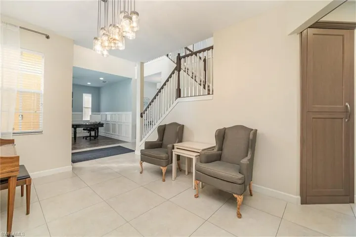 Dining room featuring light tile patterned floors and a notable chandelier