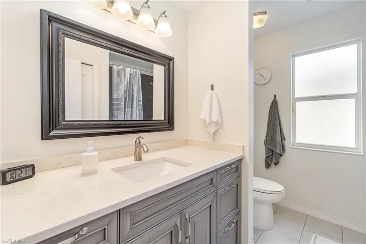Bathroom with tile patterned flooring, vanity, and toilet