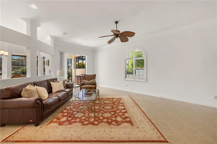 Living area with crown molding, light tile patterned floors, ceiling fan, and recessed lighting