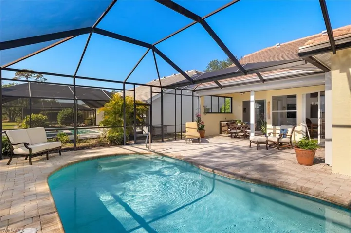 Outdoor pool featuring a sunroom, a lanai, and a patio