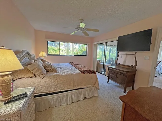 Spacious primary bedroom with queen bed and TV