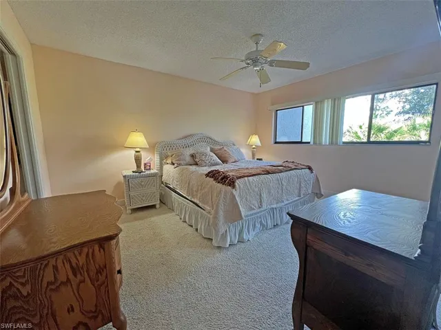 Spacious primary bedroom with queen bed and TV
