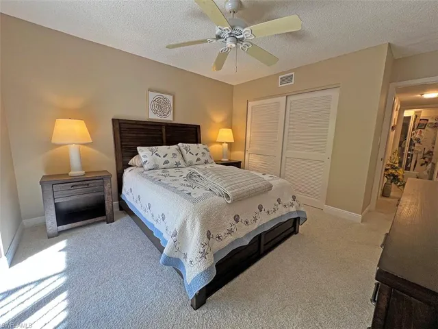 Roomy guest bedroom with queen bed and sliders to courtyard