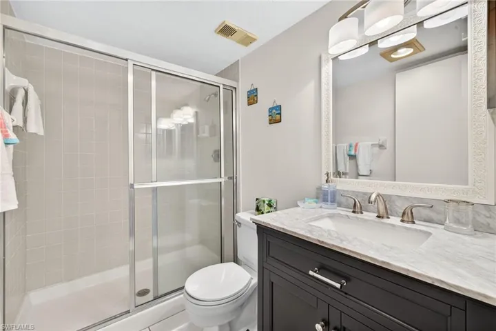 Full bath featuring a shower stall and vanity