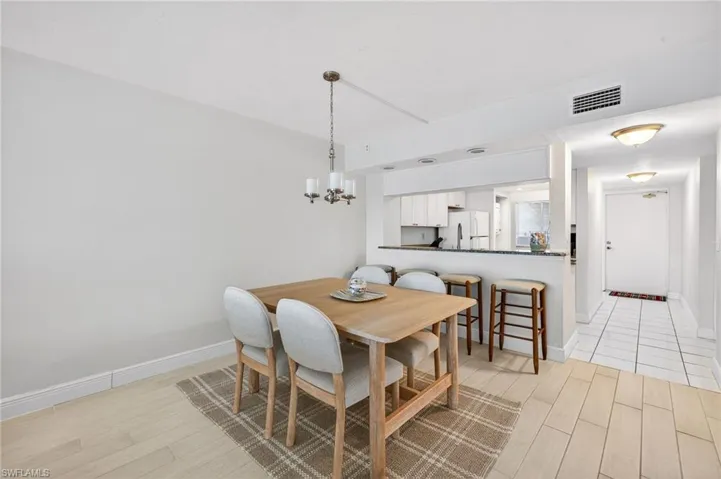 Dining space with a chandelier and light wood finished floors