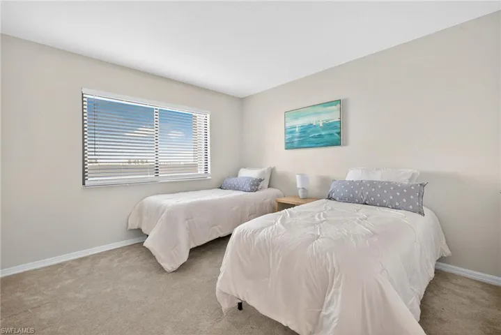 Carpeted bedroom with baseboards