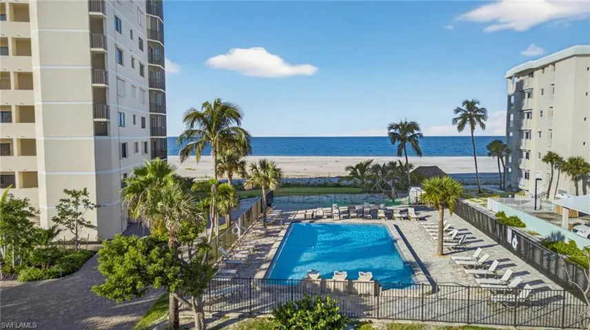 Community pool with a patio and a water view