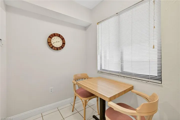Dining space featuring light tile patterned floors and baseboards