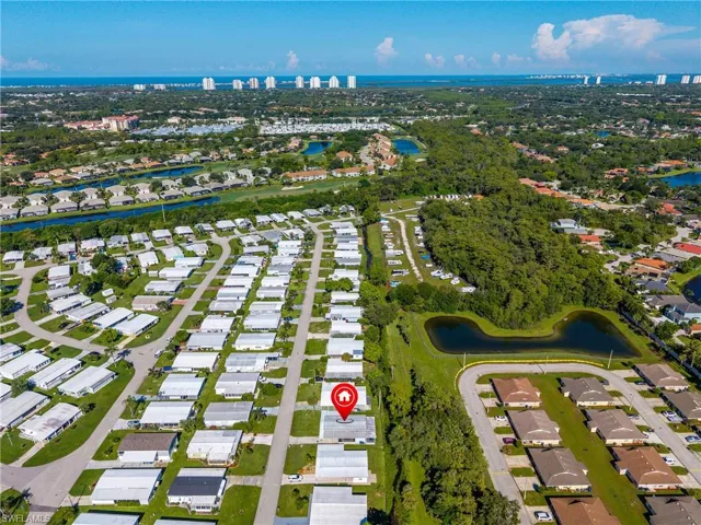 View of property location featuring a large body of water and nearby suburban area