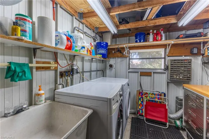 Laundry area featuring a sink and independent washer and dryer