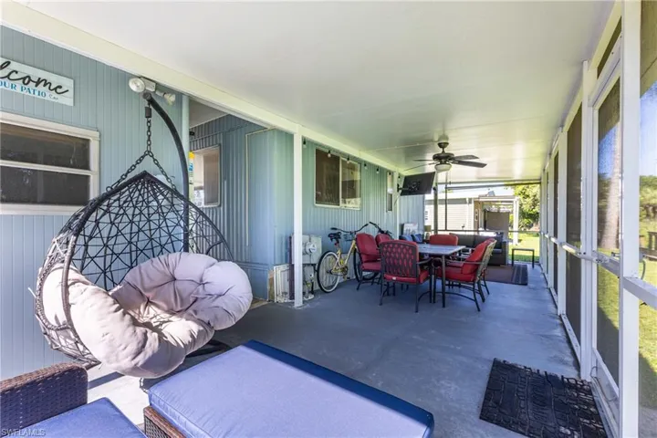 Sunroom / solarium with ceiling fan, outdoor dining area, and an outdoor living space