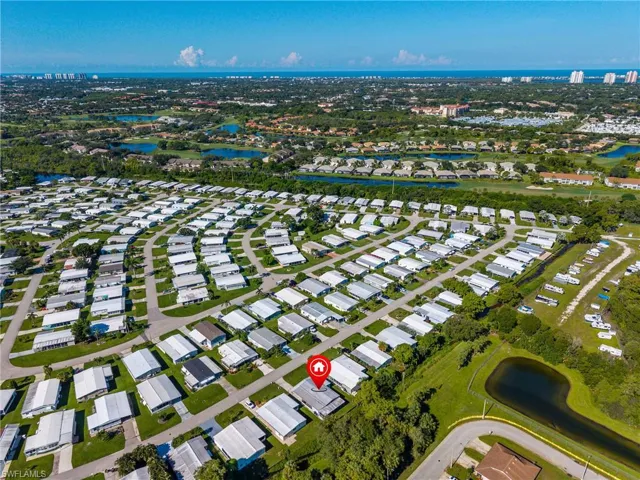 Aerial overview of property's location featuring a nearby body of water and nearby suburban area