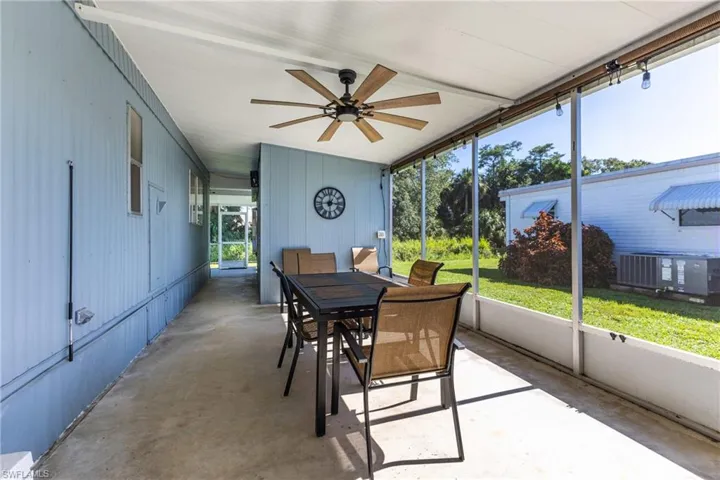 Sunroom featuring outdoor dining area and ceiling fan