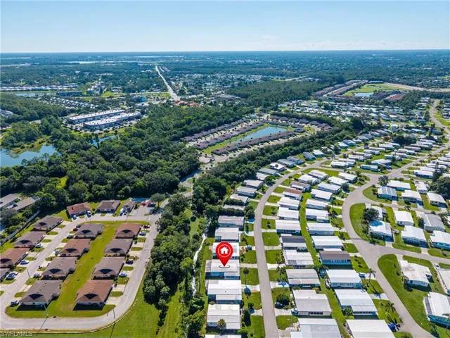 Aerial perspective of suburban area featuring a large body of water